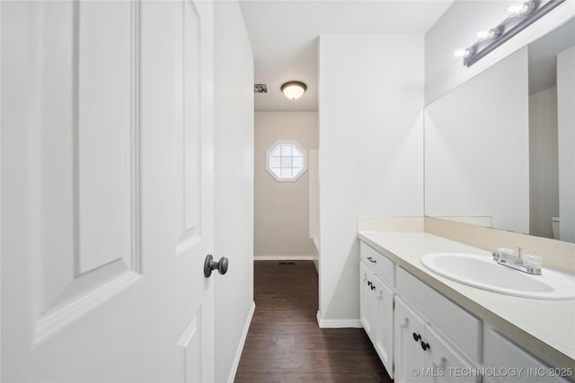 bathroom featuring hardwood / wood-style flooring, vanity, and toilet