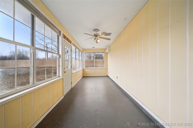 unfurnished sunroom with ceiling fan