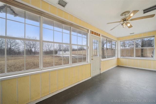 unfurnished sunroom featuring ceiling fan