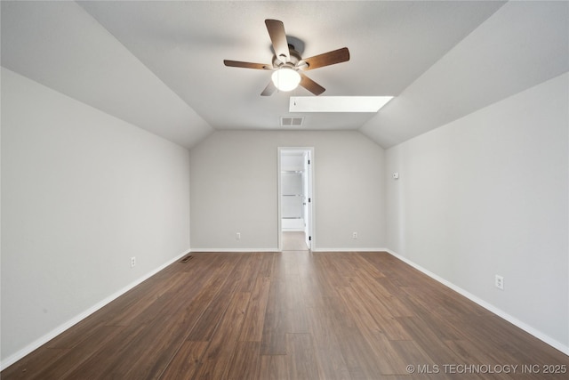 bonus room featuring vaulted ceiling with skylight, ceiling fan, and dark hardwood / wood-style flooring