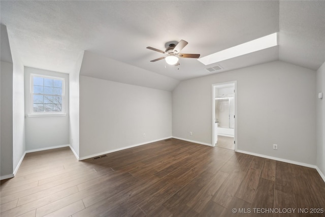 bonus room with ceiling fan, dark hardwood / wood-style floors, and vaulted ceiling