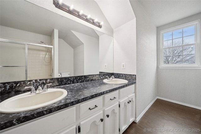 bathroom featuring an enclosed shower, vanity, vaulted ceiling, hardwood / wood-style flooring, and toilet