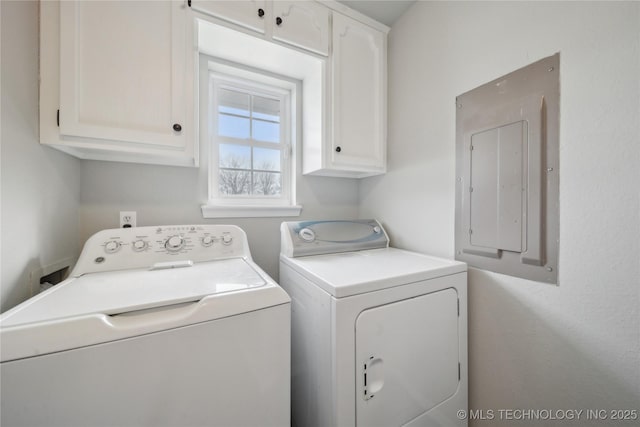 laundry area featuring cabinets, electric panel, and washing machine and clothes dryer