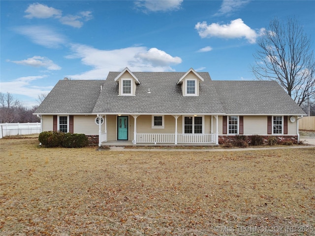 cape cod house featuring a front yard