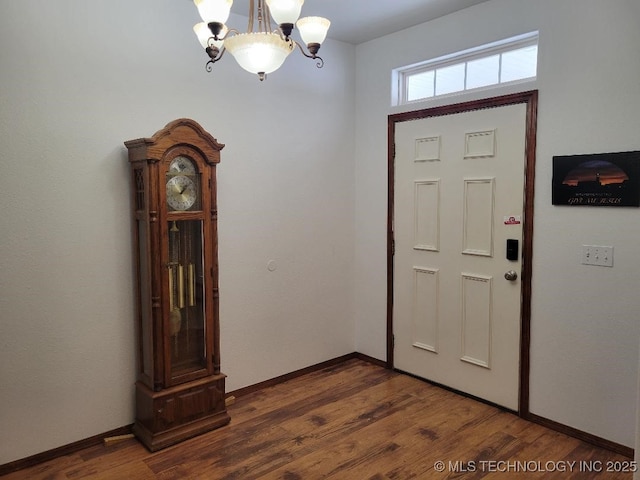 entrance foyer with dark hardwood / wood-style flooring and a chandelier