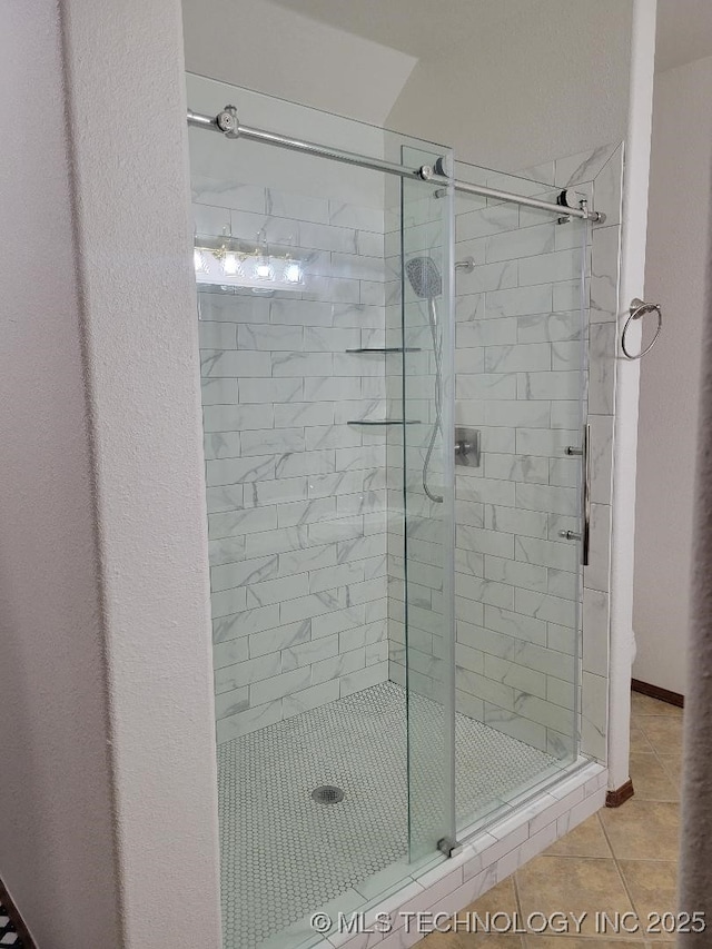 bathroom with tile patterned floors and walk in shower