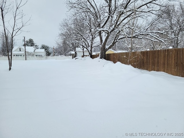 view of yard layered in snow