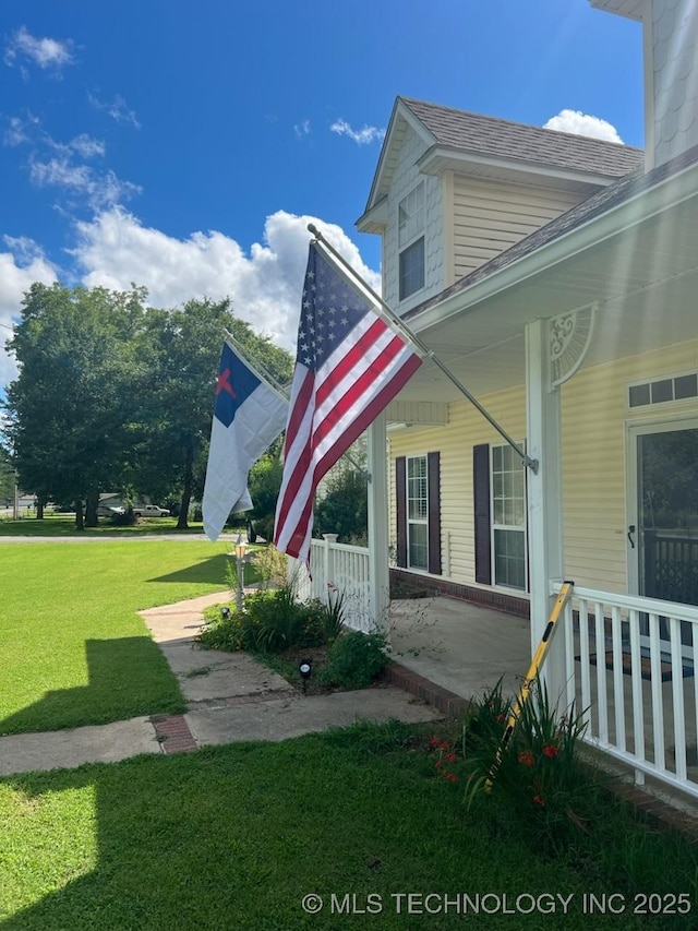 view of property exterior with a lawn and covered porch