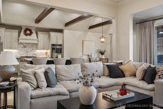 living room with vaulted ceiling with beams and a chandelier