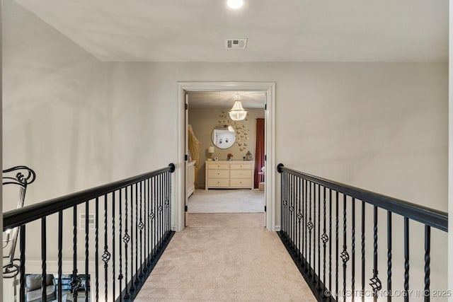 hallway featuring light colored carpet