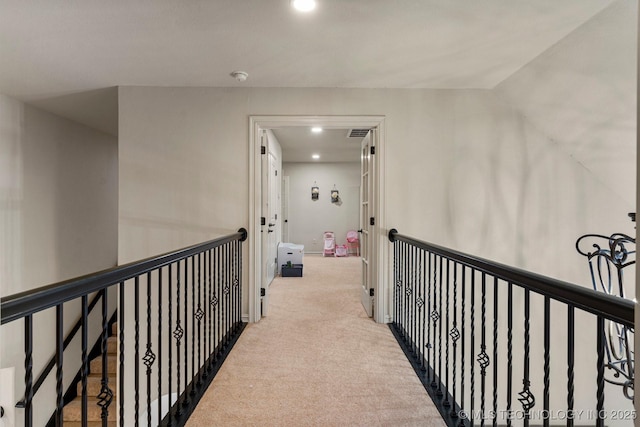 corridor featuring light colored carpet and vaulted ceiling