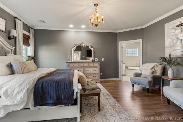 bedroom featuring hardwood / wood-style flooring, crown molding, connected bathroom, and a chandelier