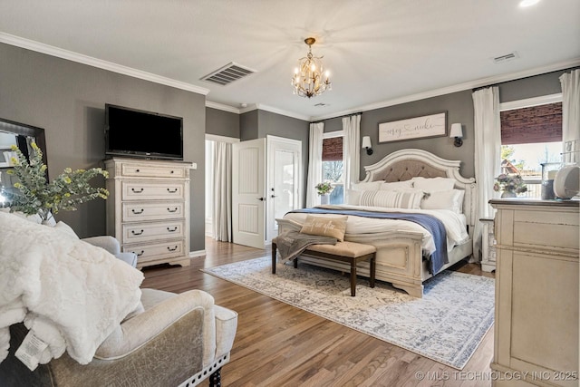 bedroom featuring multiple windows, dark hardwood / wood-style flooring, ornamental molding, and a notable chandelier