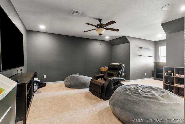 carpeted home theater room featuring a textured ceiling, ceiling fan, and lofted ceiling