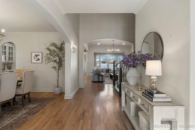 entryway featuring crown molding, a chandelier, and hardwood / wood-style flooring