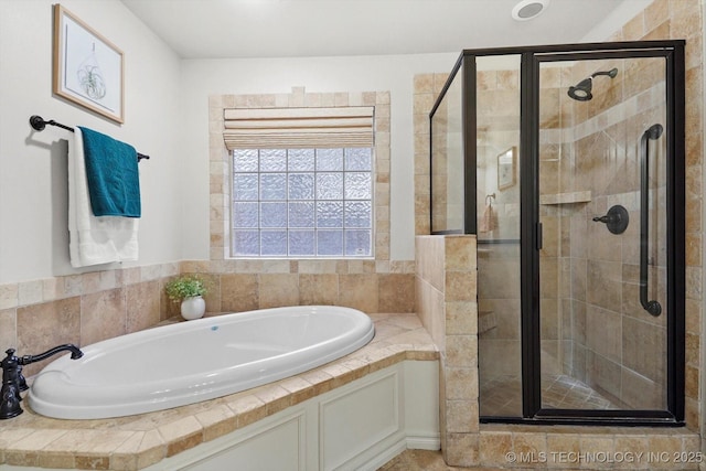 bathroom featuring separate shower and tub