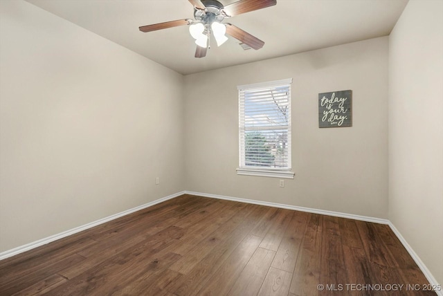 spare room with ceiling fan and dark wood-type flooring