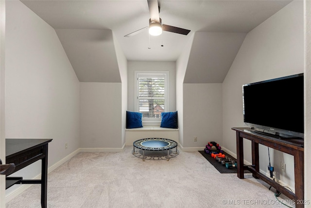 recreation room featuring ceiling fan, light carpet, and vaulted ceiling