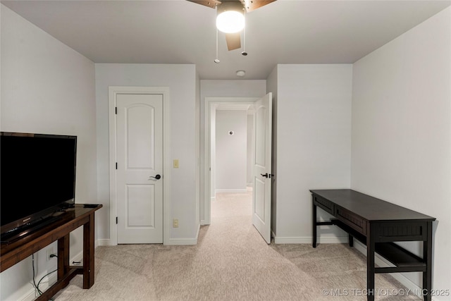 interior space with ceiling fan and light carpet