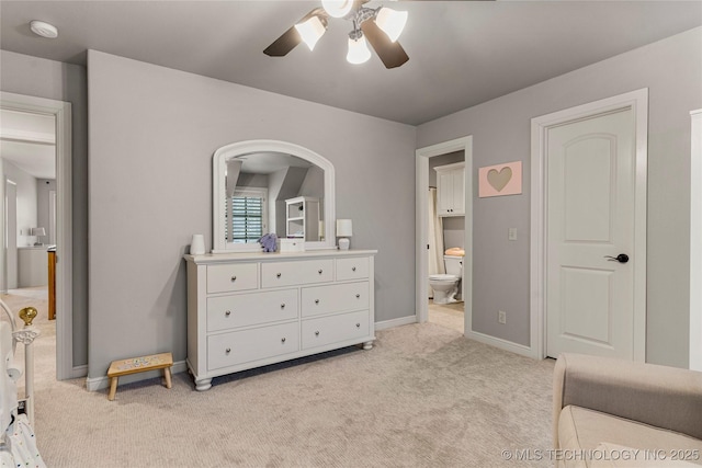 carpeted bedroom featuring ensuite bath and ceiling fan