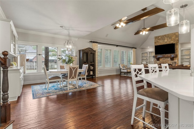 dining space with dark hardwood / wood-style flooring, ceiling fan, high vaulted ceiling, built in features, and a fireplace