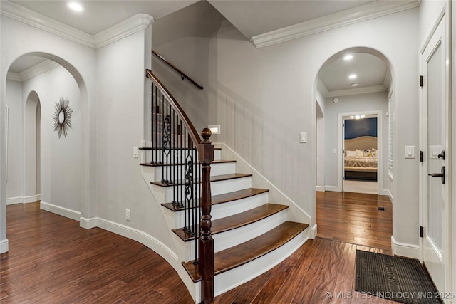 foyer entrance featuring dark hardwood / wood-style flooring and crown molding