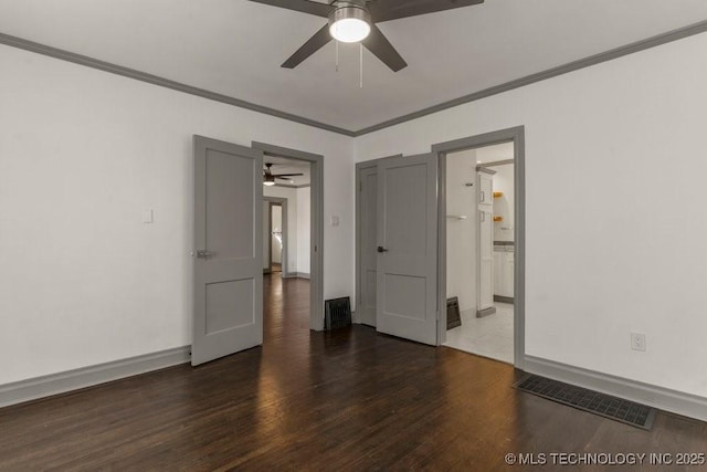 spare room featuring dark hardwood / wood-style flooring, ceiling fan, and crown molding