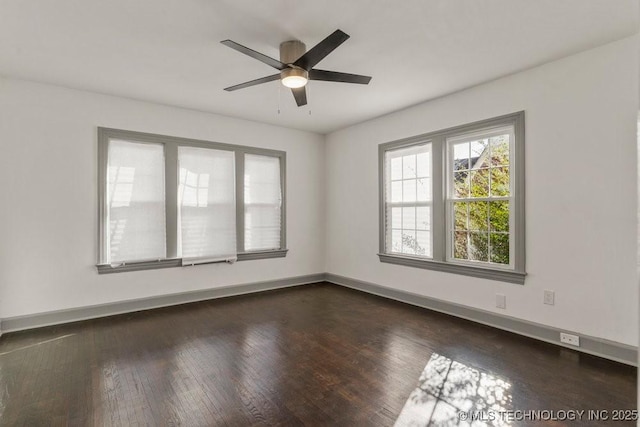 unfurnished room with ceiling fan and dark hardwood / wood-style flooring