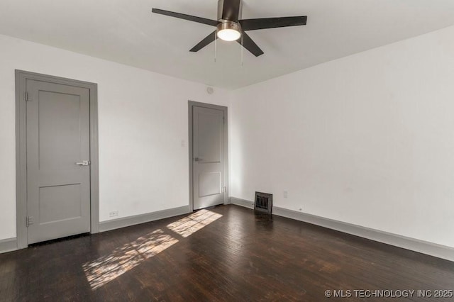 spare room featuring dark hardwood / wood-style flooring and ceiling fan