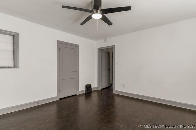 unfurnished room featuring ceiling fan and dark wood-type flooring