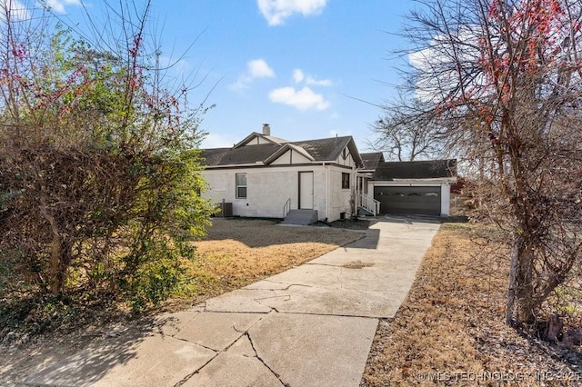 view of property exterior featuring central AC and a garage