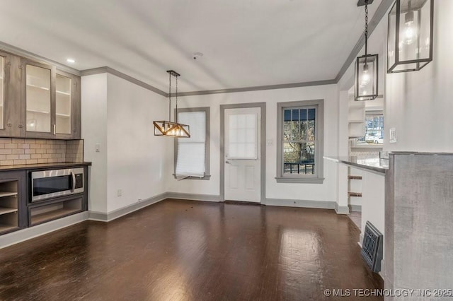 interior space featuring crown molding and dark wood-type flooring