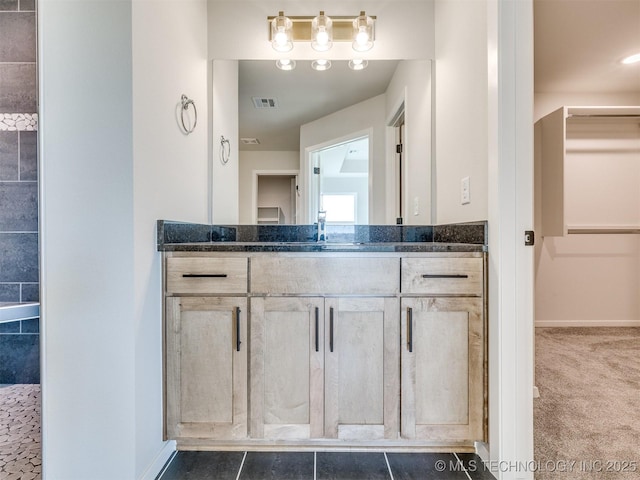 bathroom featuring tile patterned flooring and vanity