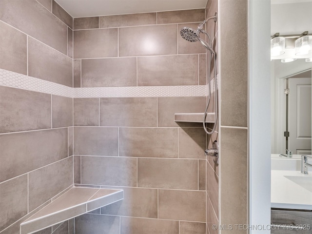 full bath featuring vanity and tiled shower