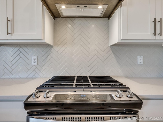 kitchen with white cabinets, stainless steel range with gas stovetop, tasteful backsplash, and ventilation hood