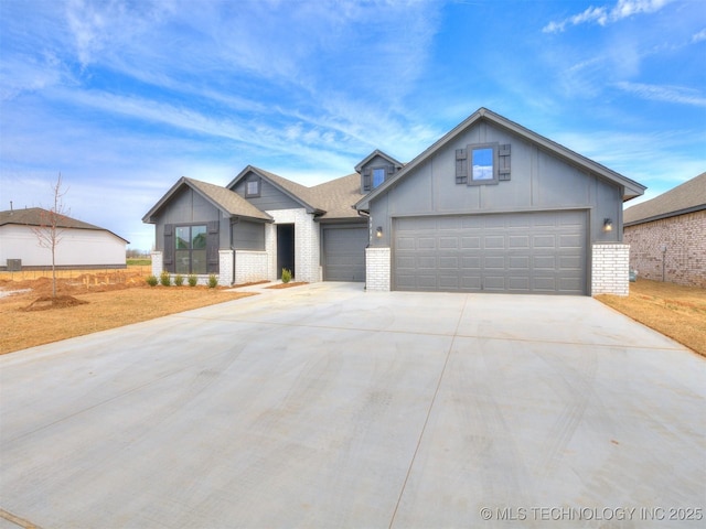 view of front facade with an attached garage, driveway, and brick siding