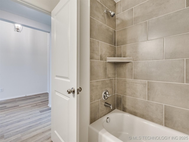 bathroom with wood finished floors and shower / bathing tub combination