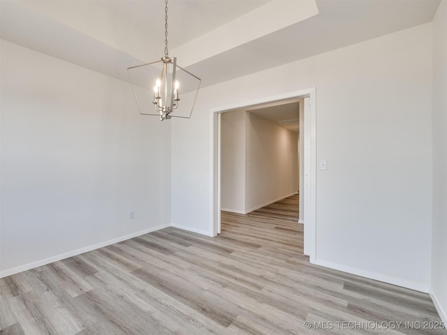 unfurnished room featuring light wood-style floors, baseboards, and an inviting chandelier