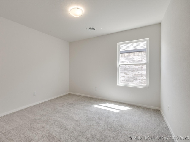 unfurnished room featuring baseboards, visible vents, and carpet