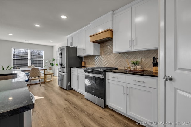 kitchen featuring decorative backsplash, white cabinets, and stainless steel appliances