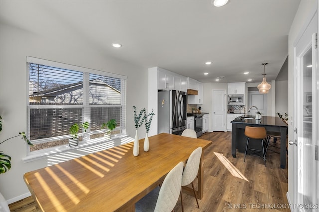 dining area featuring dark hardwood / wood-style floors and sink