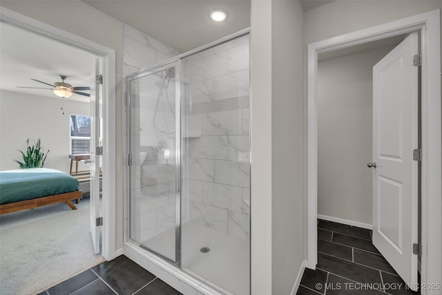 bathroom with tile patterned floors, ceiling fan, and a shower with shower door