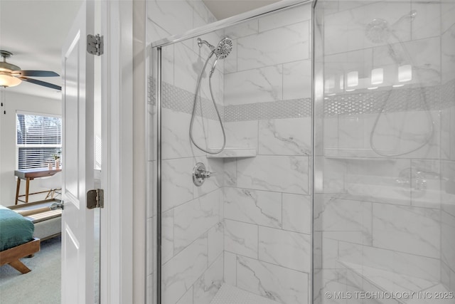 bathroom featuring ceiling fan and an enclosed shower