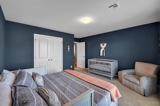 bedroom with light carpet and a closet