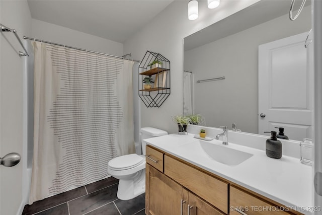 bathroom with a shower with shower curtain, tile patterned floors, vanity, and toilet