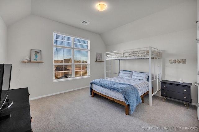 bedroom with carpet and vaulted ceiling