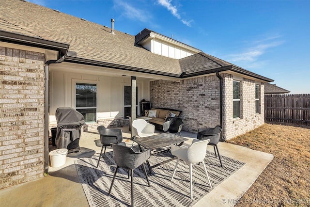 view of patio with area for grilling and an outdoor living space