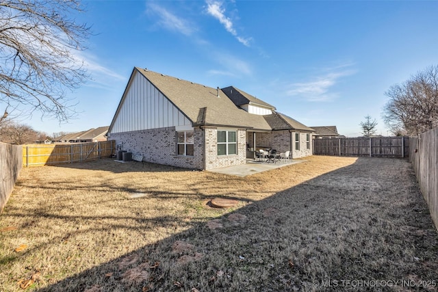 back of property with a patio area and central AC