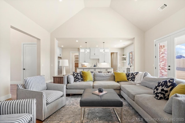 living room featuring wood-type flooring and vaulted ceiling