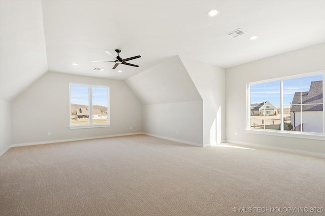 bonus room with ceiling fan, light colored carpet, and vaulted ceiling
